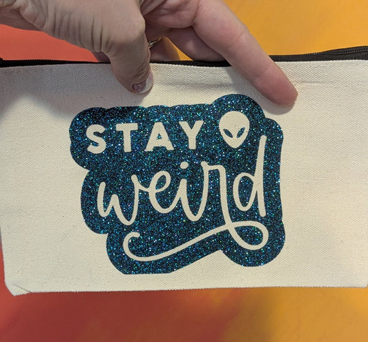 stay weird zip clutch
