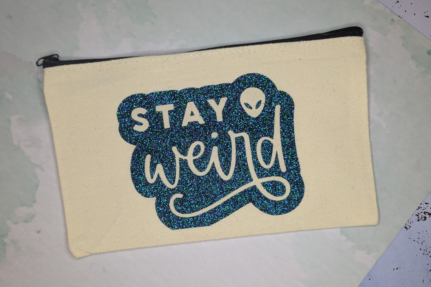 stay weird zip clutch